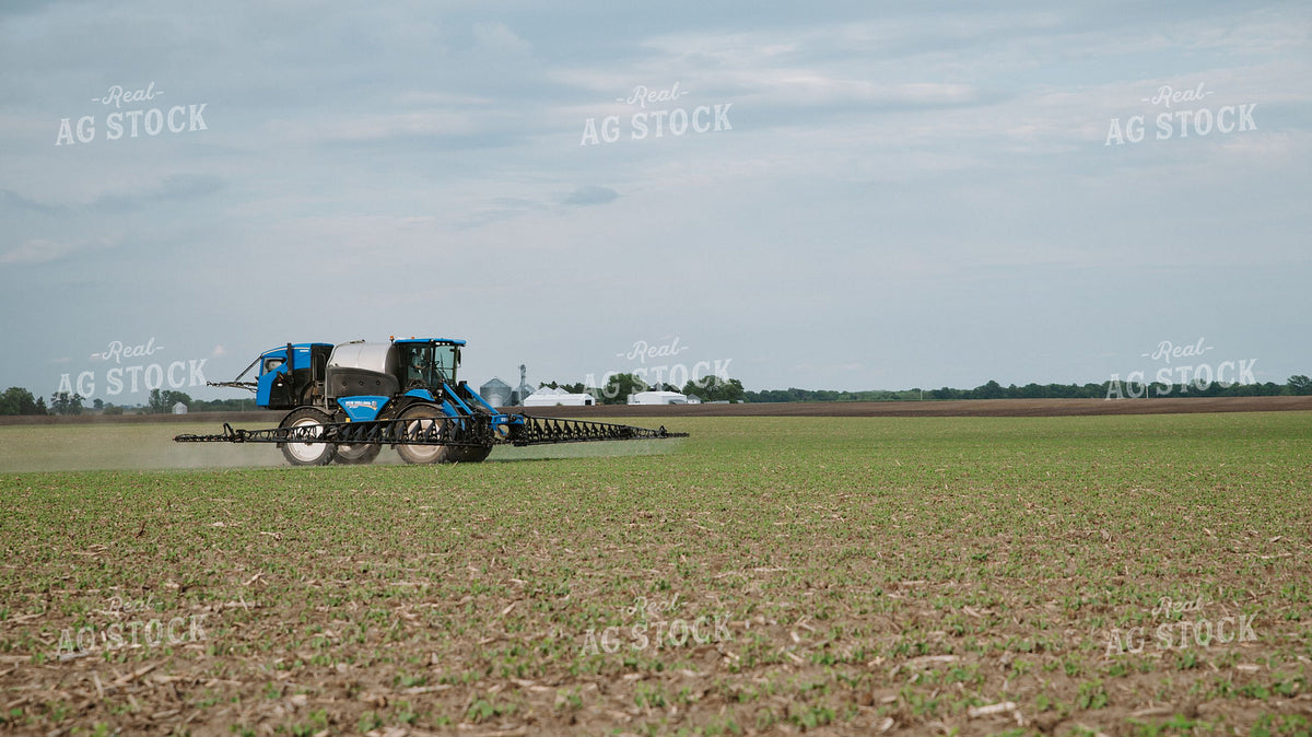 New Holland Self-Propelled Sprayer Applying Crop Protection to Early-Season Field 401041