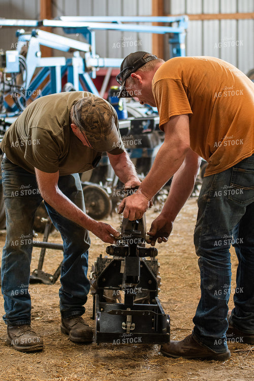 Farmers Working in Shed 50267