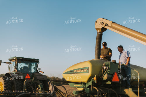 Farmers Fill Planter with Seed Tender in Field 7709