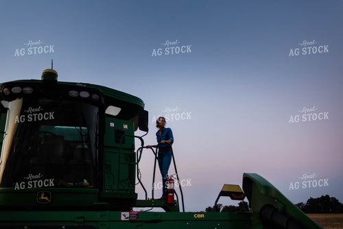 Female Farmer Climbing into Combine 8400
