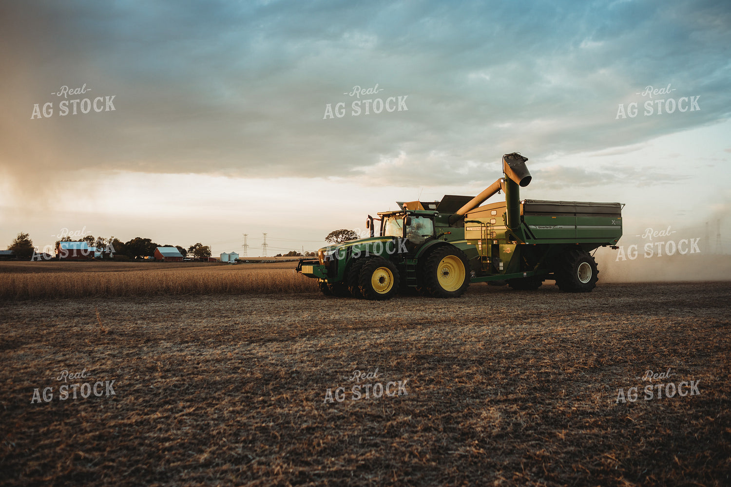 Combine Unloading on the go into Grain Cart at Sunset 3461