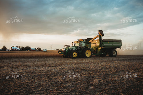 Combine Unloading on the go into Grain Cart at Sunset 3461