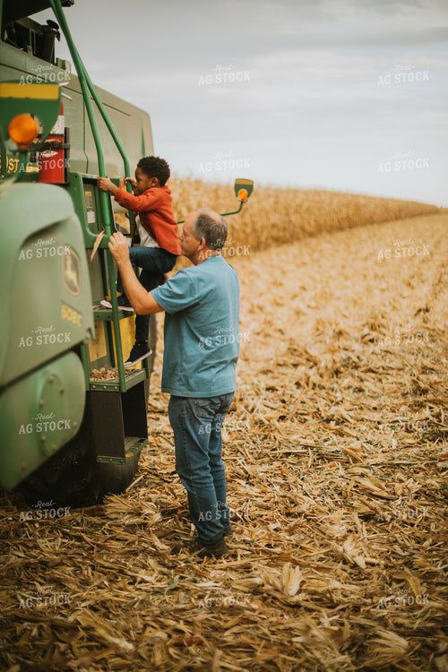 Farmer and Farm Kid Getting into Combine 6661