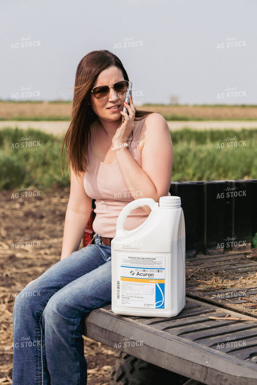 Female Farmer Talks on Phone Sitting on Ranger Tailgate 67286