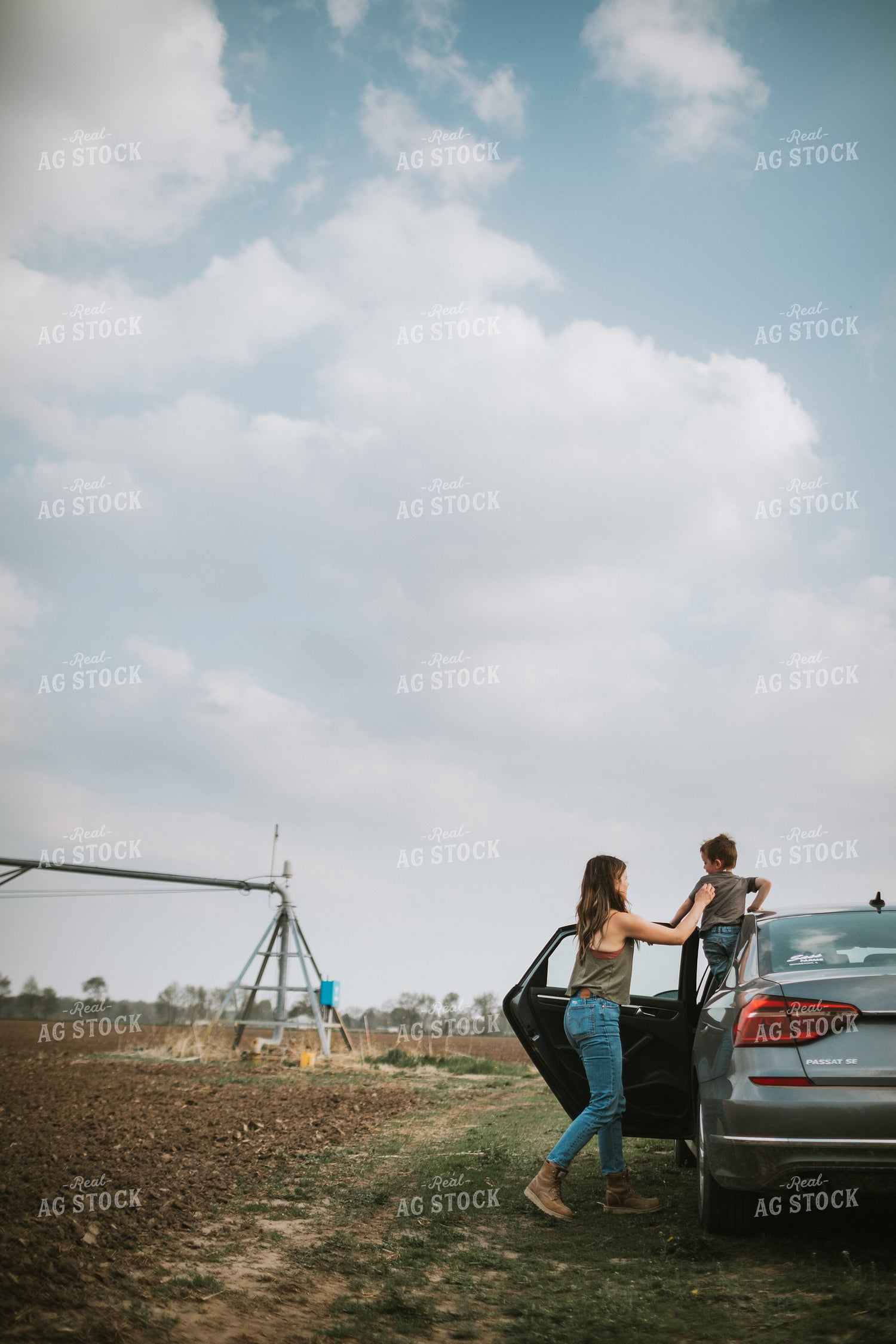 Farm Mom and Kid Arriving at Field During Planting 5598