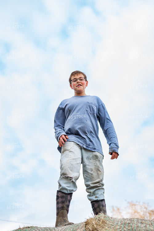Farm Kid Climbing on Hay Bale 155576