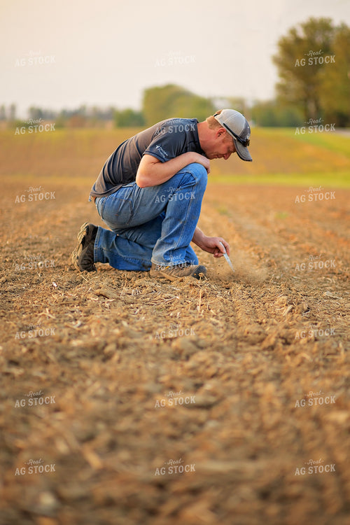 Farmer Checks Seed Depth After Planting 93205