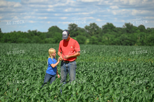Farmer and Daughter Scouting Corn Field 191331