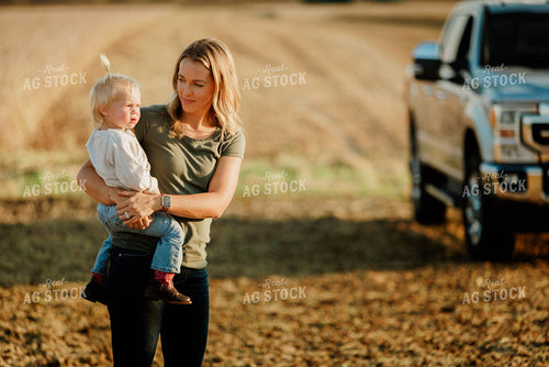 Farm Wife Holding Daugher in Field 9236