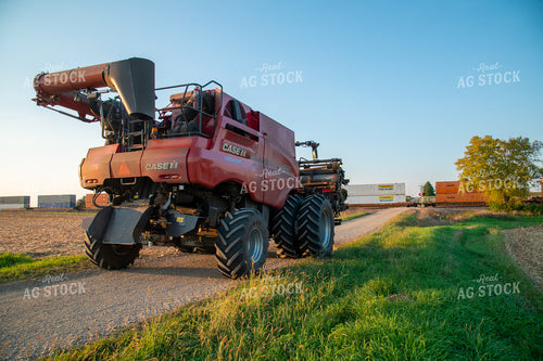 Combine Waiting for Train at Railroad Tracks 25449