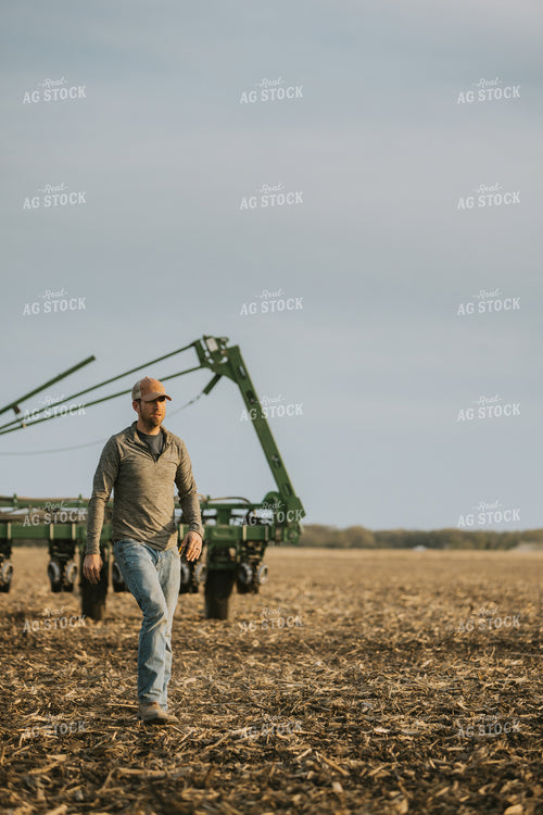 Farmer Walking in Field by Planter 8213