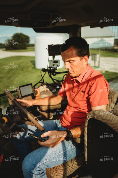 Farmer with Tractor Cab Monitors and Smart Phone 4466