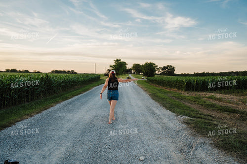 Female Farmer Walking up Driveway 115302