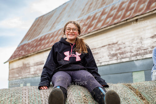 Farm Kid Climbing on Hay Bale 155577