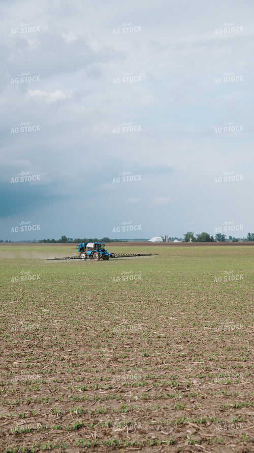 Self-Propelled Sprayer Applying Crop Protection to Early Growth Field 401022