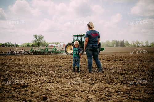 Farm Kid and Mom Watching Tractor in Field 169092