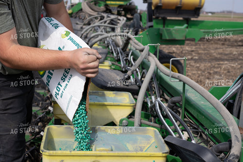 Farmers Pours Seed into Planter 133012