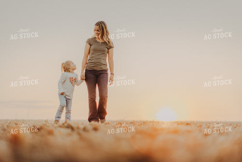 Farm Wife Walking with Daugher in Field 9270