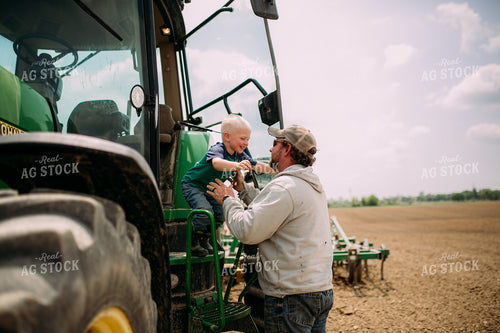 Farmer Helping Son Out of Tractor 169079