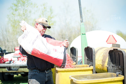Farmer Putting Seed into Planter 74044