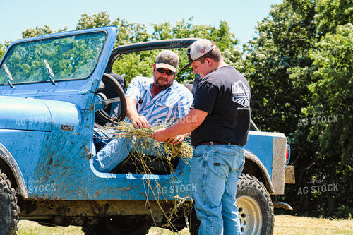 Farmer and Son Checking Cut Hay 214029