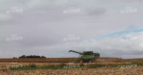 Combine Picking Corn as Grain Cart Pulls Up Alongside It 3917