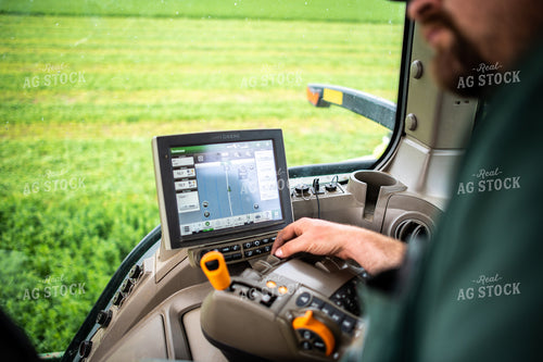 Farmer Driving Tractor with Equipment GPS Monitor Visible 56670