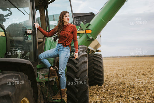 Female Farmer Cimbing into Tractor 8553