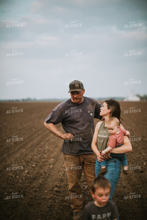 Farm Family in Field During Planting 5694
