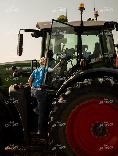 Female Farmer Climbing into Tractor 185233