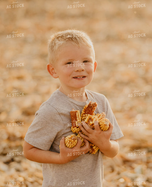 Farm Kid Holding Ears of Corn 185127