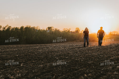 Young Couple Walk in Field at Sunset 7724