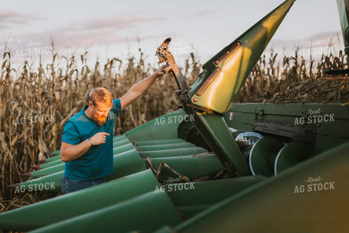 Farmer Fixing Combine Head 9392