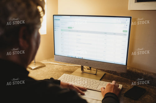 Farmer Using Computer for Farm Accounting 3702