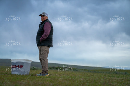 Man Standing Outdoors on Open Field with Overcast Sky 65287