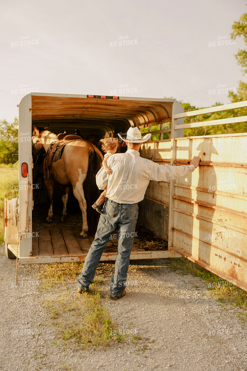 Rancher and Kid Loading Horse 207029