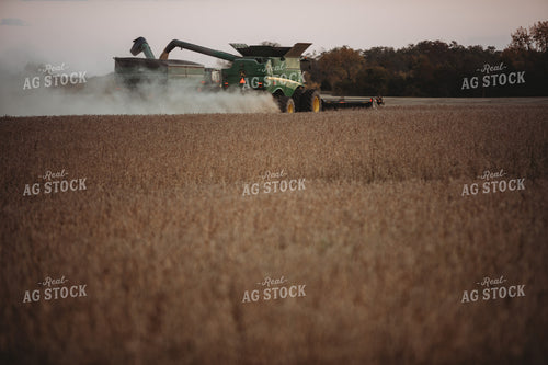 Combine Unloading on the go into Grain Cart at Dusk 3484