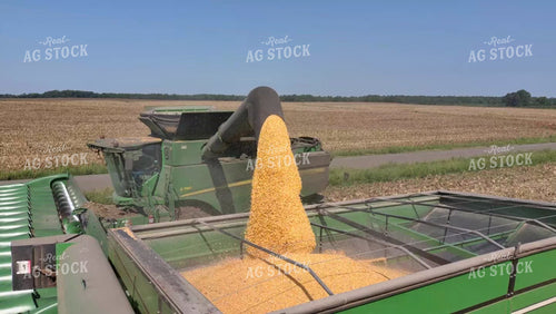 Aerial Close Up of Combine Loading Grain Cart with Corn 79214