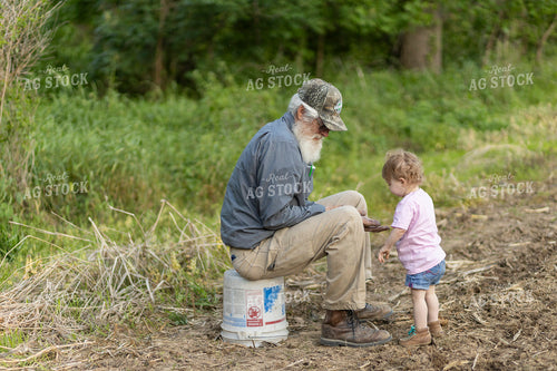 Farmer with Farm Kid in Field 93256