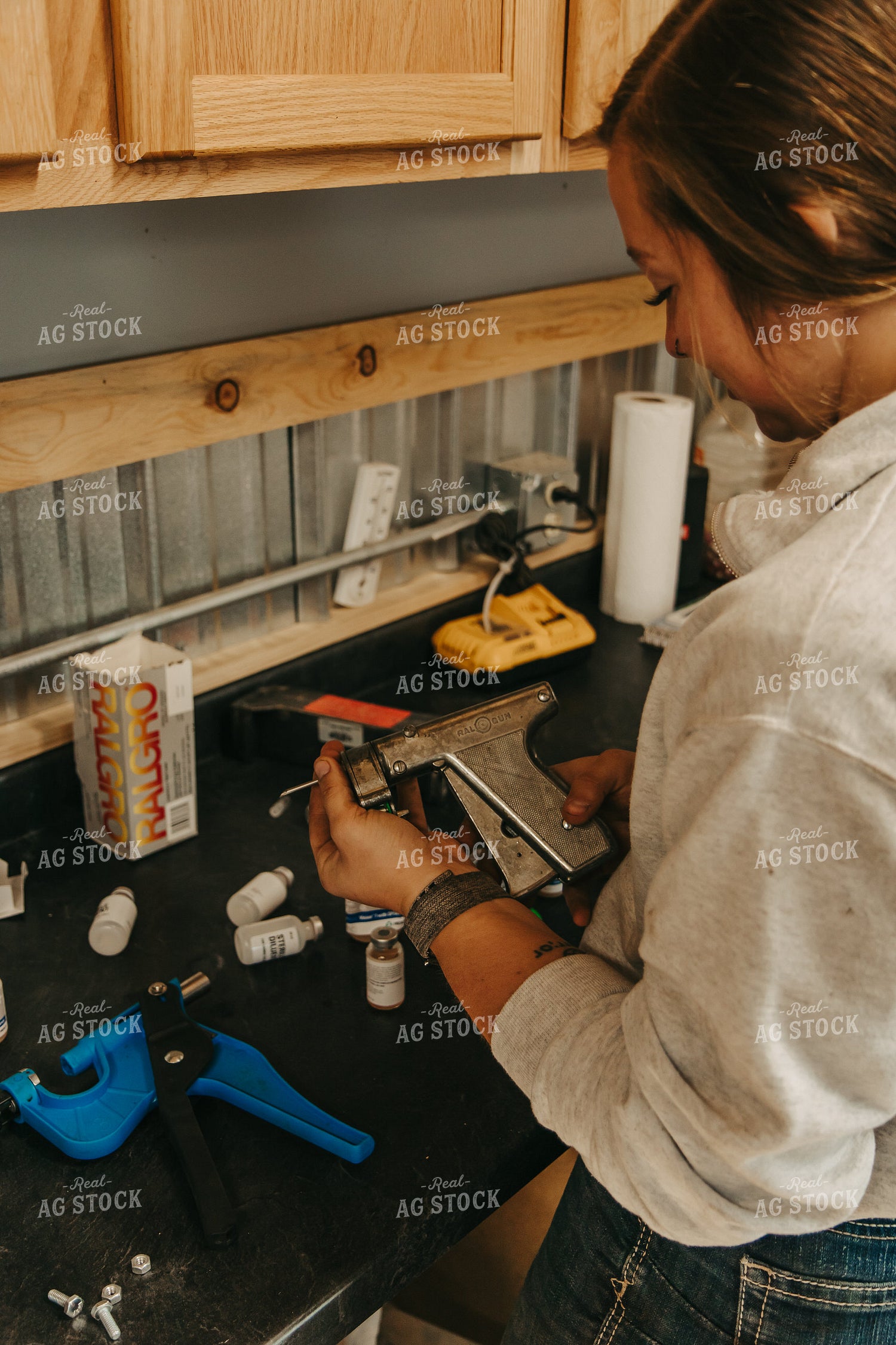 Female Rancher Preparing Implant Injector 67531