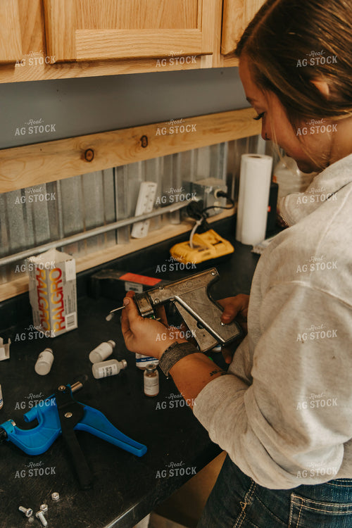 Female Rancher Preparing Implant Injector 67531
