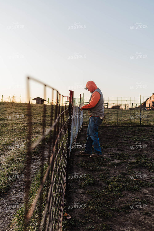 Farmer Fixing Fence 115140