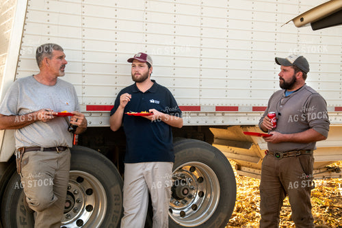 Family Enjoying Harvest Meal in the Field 25809