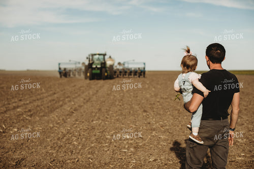 Farmer and Daughter with Tractor and Planter in Background 4186