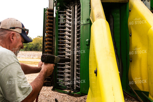 Farmer Fixing Cotton Harvester 128059