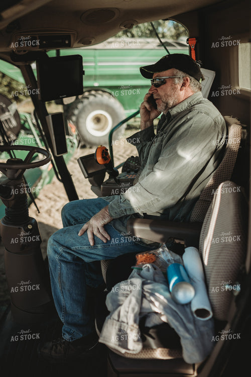Farmer Talking on Phone in Combine Cab 5227