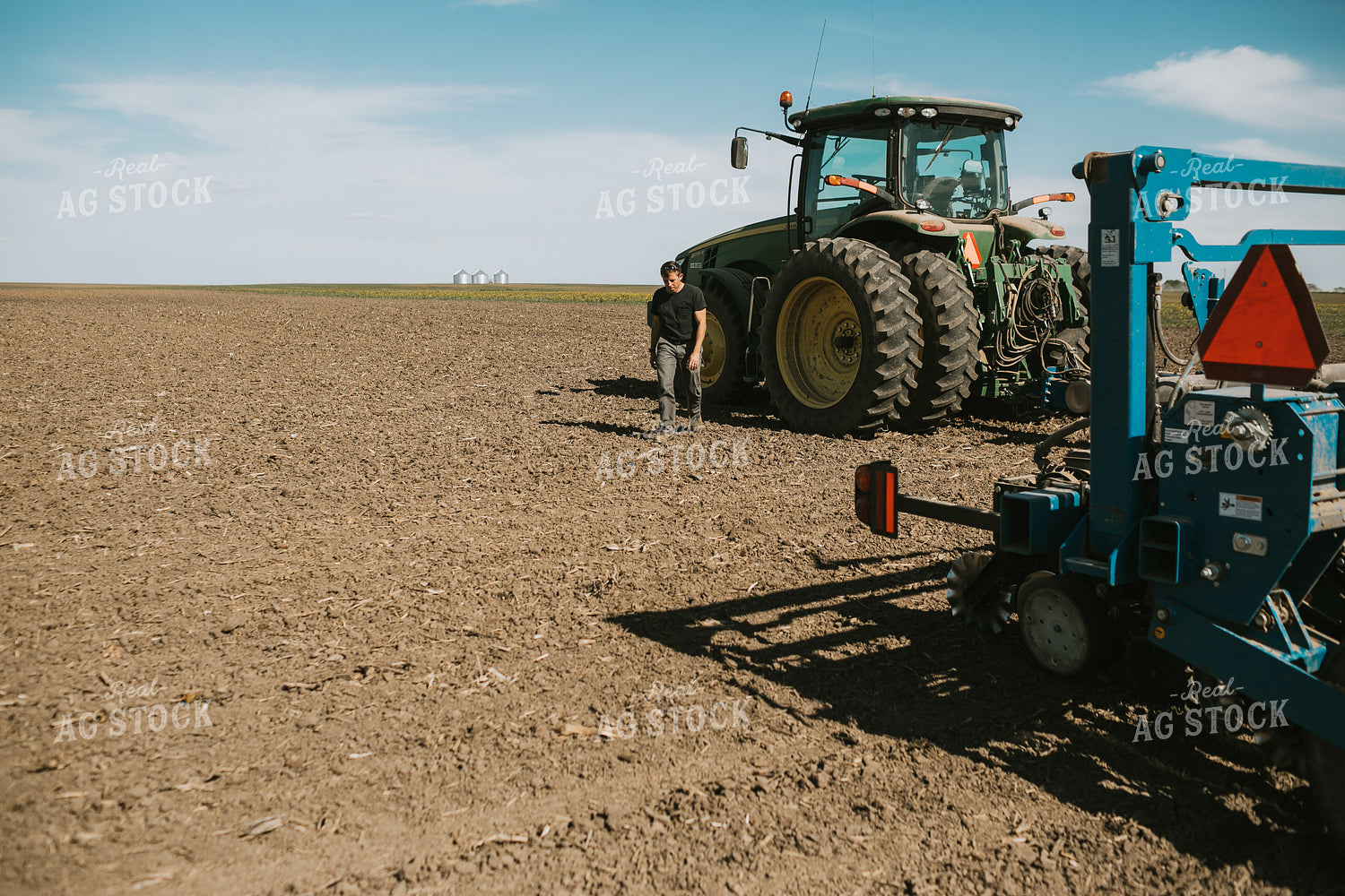 Farmer Climbing out of Tractor with Planter 4283