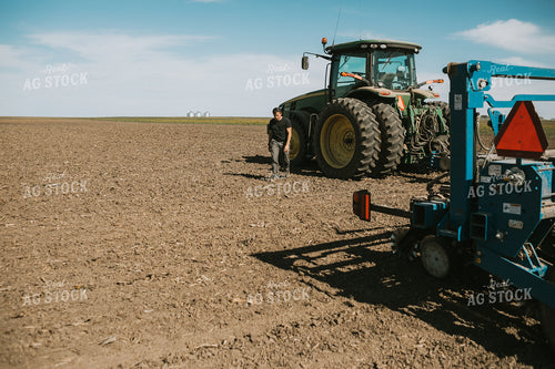 Farmer Climbing out of Tractor with Planter 4283