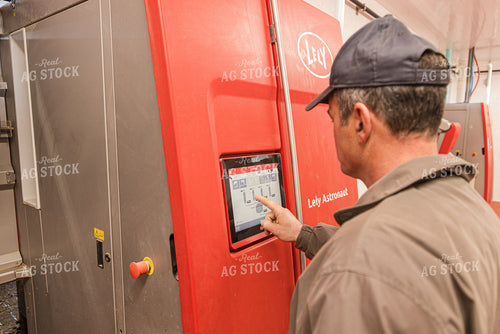 Farmer Adjusting Robotic Milking Unit 270282