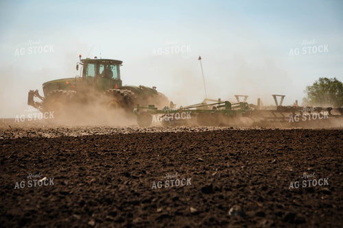 Large Tractor Plowing Field on a Dusty Spring Day 152486